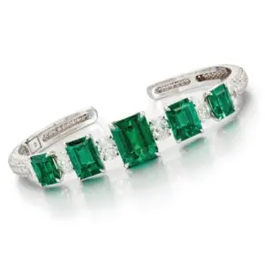Cuff bangle containing five emeralds